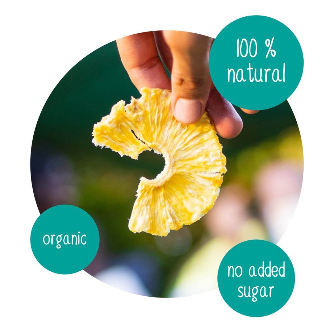 Hand holding a slice of DoGood organic dried pineapple – 100% natural, no added sugar, healthy fruit snack